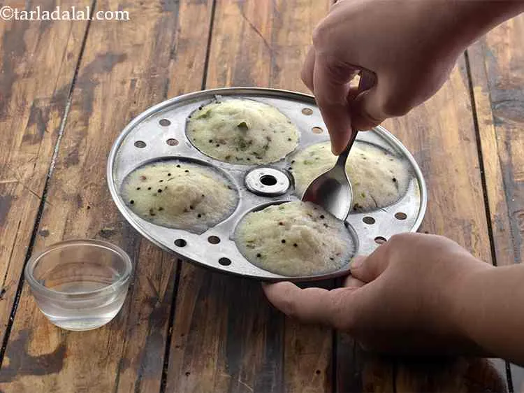 Step 20 – Cool slightly and remove the <strong>suji idli</strong> from the mould. If you are facing difficulty …