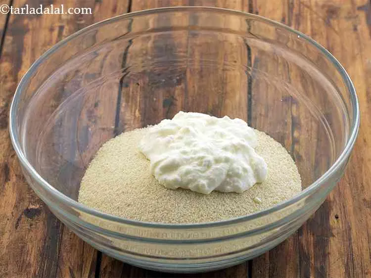 Step 2 – Add the curd to it. It is the fresh curd that makes the rava idli …