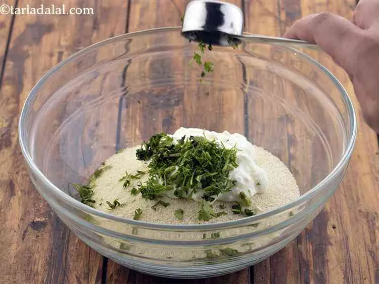 Step 3 – Now add chopped coriander. Dhania is an optional ingredients for the <strong>suji idli recipe</strong>.