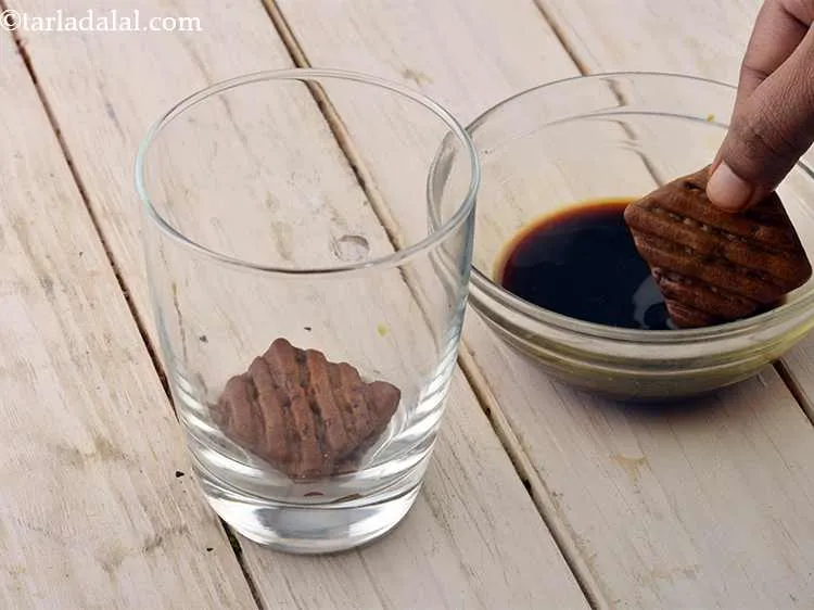 Step 7 – Take 1 hide and seek biscuit dip in the coffee water solution and place it …