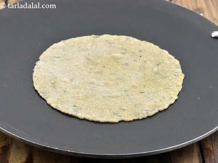 Step 20 – Heat a concave non-stick tava (griddle) and half cook the roti.