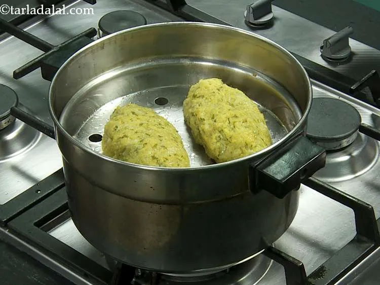 Step 21 – Steam in a steamer for 12 minutes or till a knife inserted into the muthia …