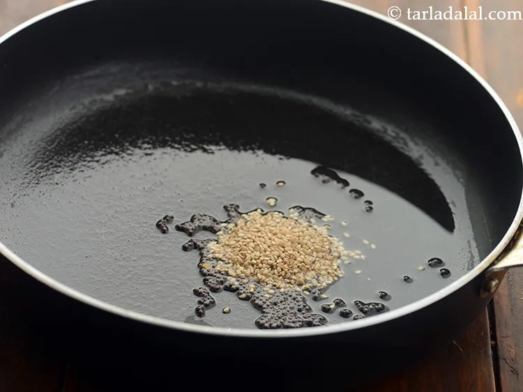 Step 26 – Add 2 tsp&nbsp;<a href="https://www.tarladalal.com/glossary-sesame-seeds-til-gingelly-seeds-612i">sesame seeds (til)</a>.