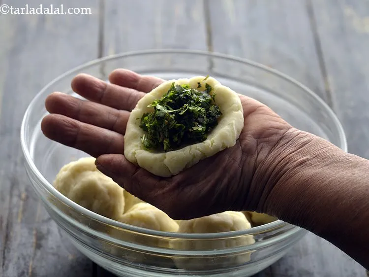 Step 39 – Place 2 tsp of the mint leaves and coriander mixture in the center of the …