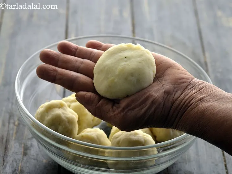 Step 41 – Completely seal the filling inside the potato and lightly press it again in between the …