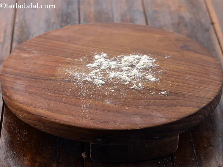 Step 20 – Sprinkle little ragi flour on the rolling board to avoid the ragi bhakri from sticking …
