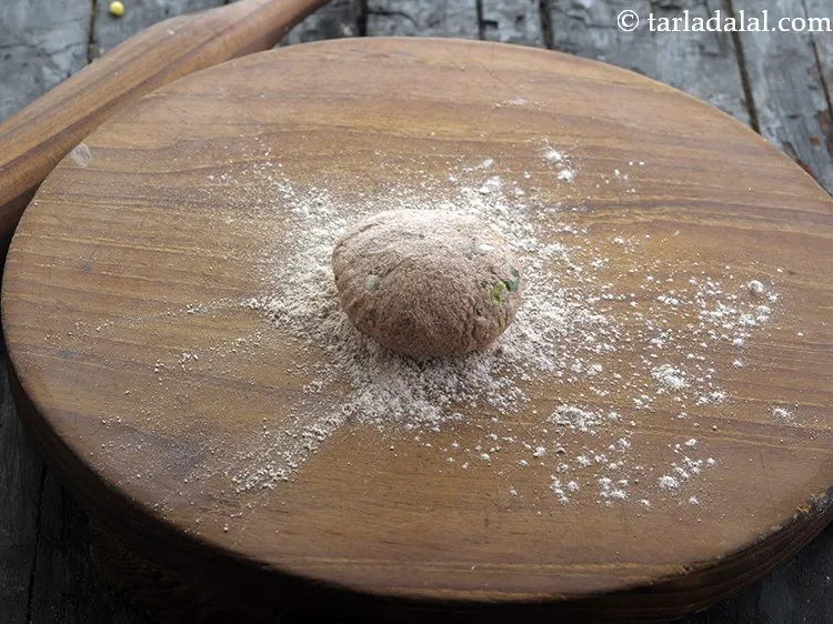 Step 14 – To cook the ragi roti, take a portion of dough and press it between your …