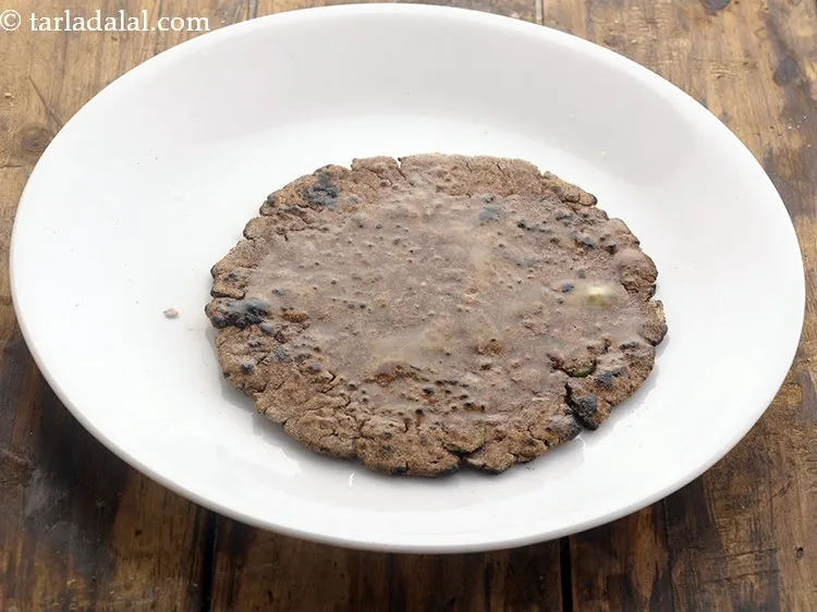 Step 23 – Brush each ragi chapati with a little butter. You can use ghee also to keep …