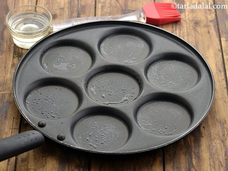 Step 21 – Lower the flame and grease it lightly using &frac14; tsp of oil.