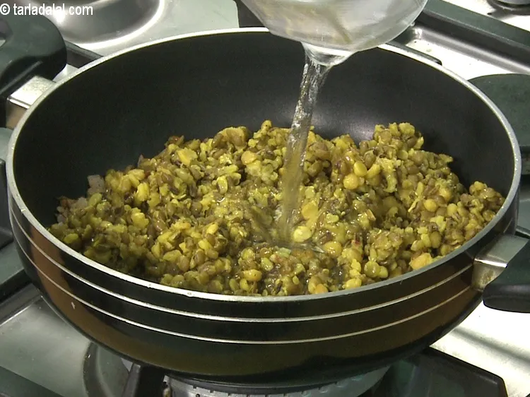 Step 45 – <meta charset="UTF-8" /> Add the cooked dals and &frac12; cup of water and mix well.