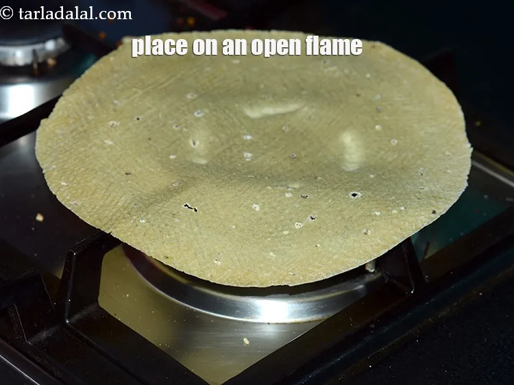Step 4 – Place a Bikaneri papad on an open flame.