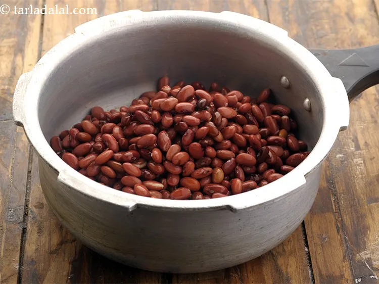 Step 5 – <p>In a pressure cooker, add rajma.&nbsp;</p>