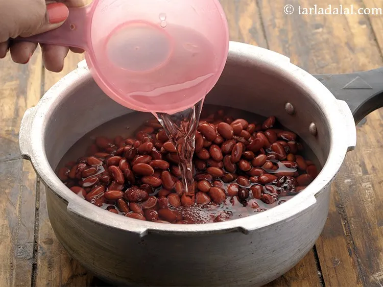 Step 7 – <p>Add 2 cups of water in the pressure cooker.</p>