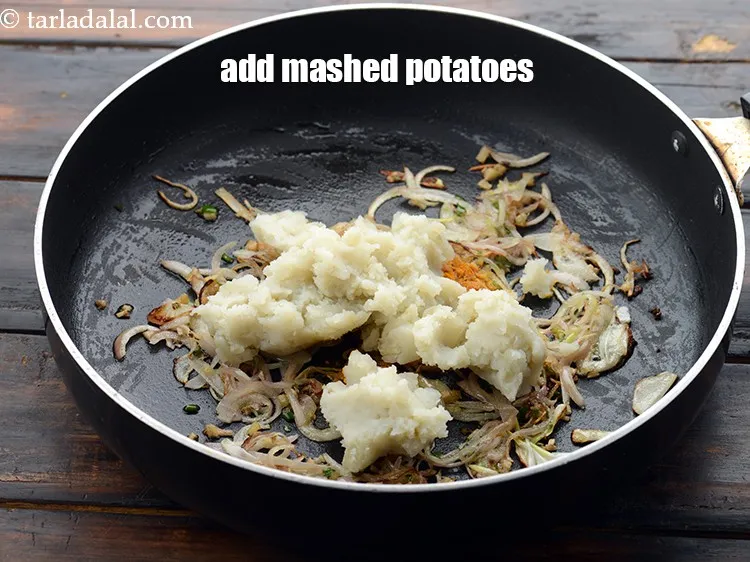 Step 30 – Add 1/2 cup&nbsp;<a href="https://www.tarladalal.com/glossary-boiled-and-mashed-potatoes-1831i">boiled , peeled and mashed potatoes</a>.