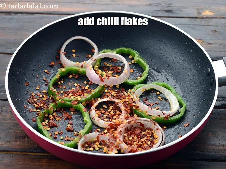 Step 54 – Add 1 tbsp&nbsp;<a href="https://www.tarladalal.com/glossary-dry-red-chilli-flakes-paprika-338i">dry red chilli flakes (paprika)</a>.
