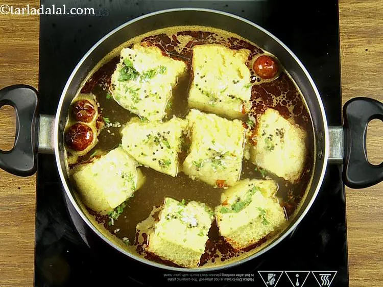 Step 32 – Add 8 pieces of <strong>khaman dhoklas</strong>. If you are not going to eat the rasawala …