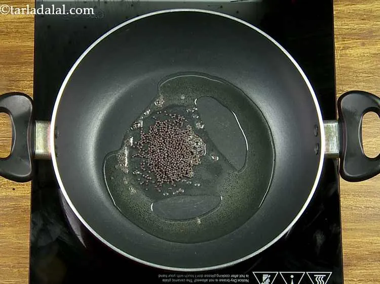 Step 23 – When the oil is moderately hot, add the mustard seeds.