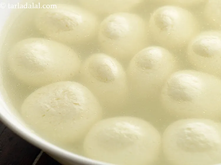 Step 26 – Remove&nbsp;<strong>Bengali rasgulla</strong>&nbsp;gently into a bowl. They will shrink a little after switching off the flame …