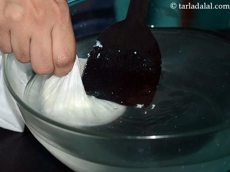 Step 13 – Place the muslin cloth with the chenna in a bowl of freshwater and wash it …