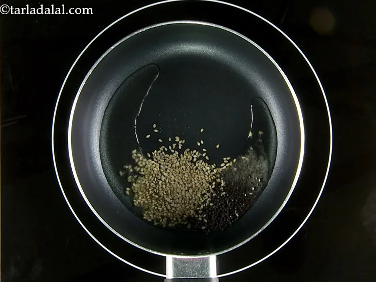 Step 28 – Add the sesame seeds. These seeds provide a nice aroma and flavor to the dhokla.