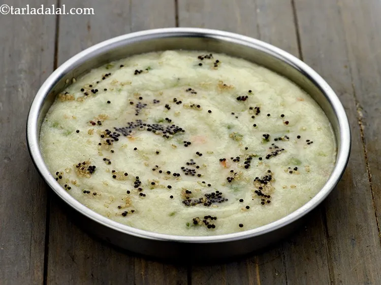 Step 30 – Pour the tempering over the prepared&nbsp;<strong>Rava Vegetable Dhoklas</strong>&nbsp;with the help of a spoon. The tempering …
