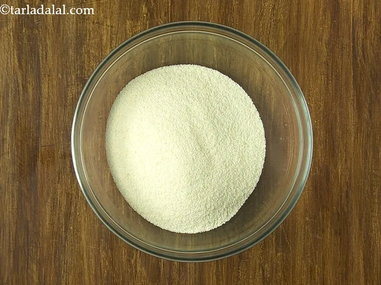 Step 7 – For the batter of quick&nbsp;<strong>Rava Vegetable Dhoklas</strong>, in a deep bowl, put the semolina.