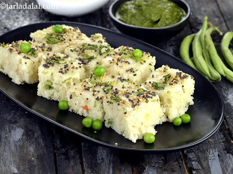Step 32 – Serve the <strong>Rava Vegetable Dhoklas</strong>&nbsp;hot with green chutney.