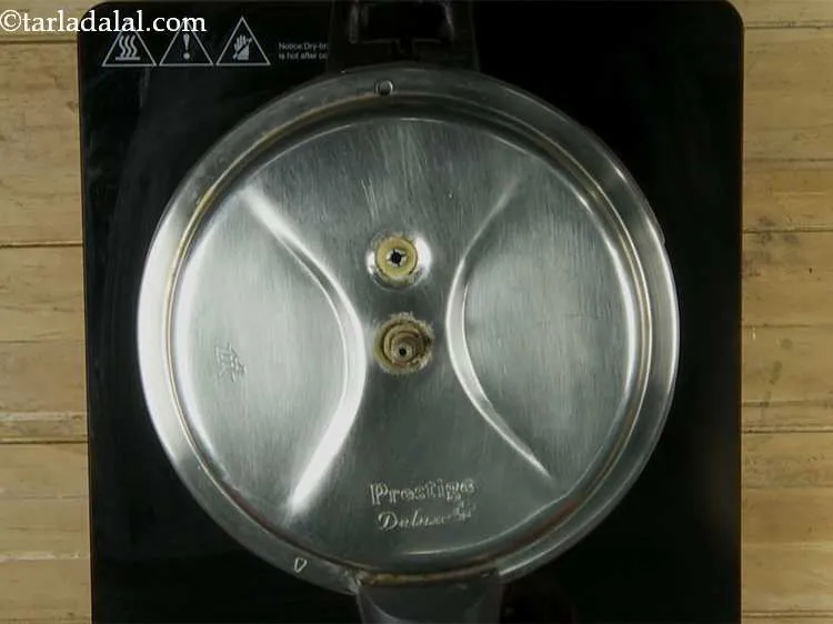 Step 16 – Close the lid of the pressure cooker and cook on a slow flame for 20 …