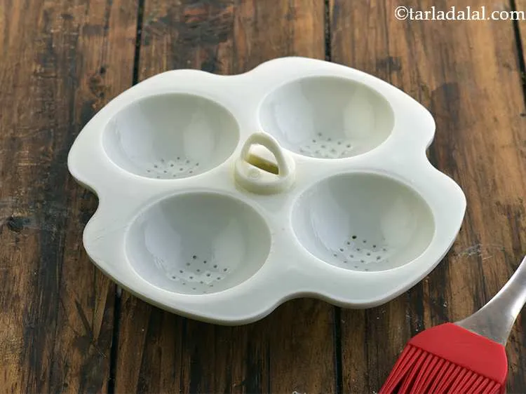 Step 18 – Grease the idli moulds using little oil.