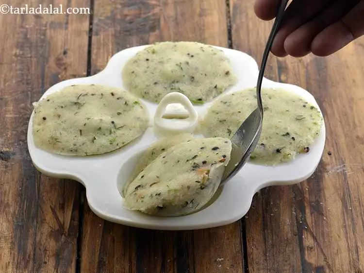 Step 26 – Cool slightly and remove the <strong>rava idli</strong> from the mould. If you are facing difficulty …