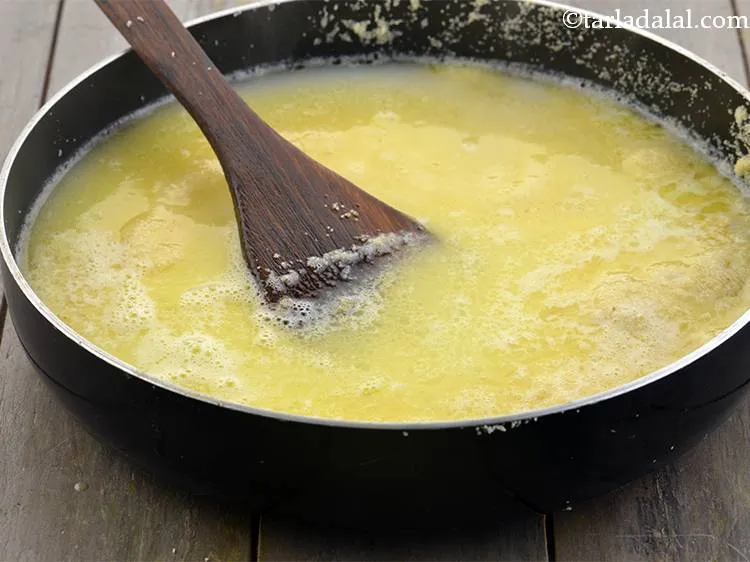 Step 16 – Add 2&frac12; cups of hot water. These liquids will help in cooking the semolina properly.