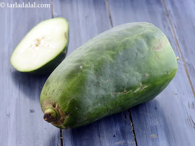 Step 3 – Wash and peel the raw papaya.&nbsp;Remove the top and bottom&nbsp; skin off the papaya with …