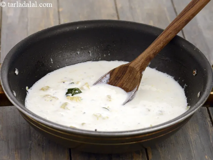 Step 18 – Add the curd-coconut milk mixture.