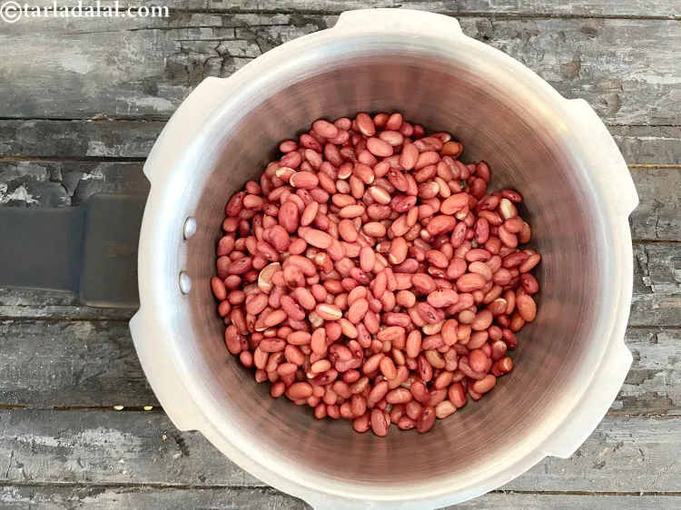 Step 64 – In a pressure cooker put soaked &nbsp;<a href="https://www.tarladalal.com/glossary-rajma-kidney-beans-197i">rajma (kidney beans)</a>.