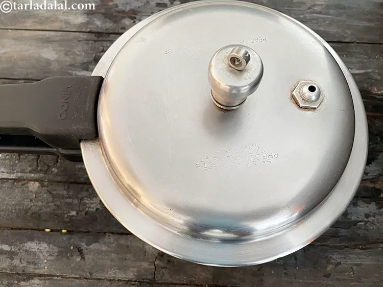 Step 71 – Pressure cook for 5 whistles.&nbsp;Allow the steam to escape before opening the lid.