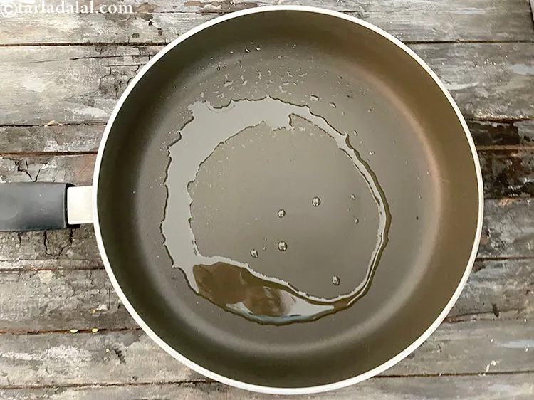 Step 74 – Heat 1/2 tablespoon oil in a broad non-stick pan.