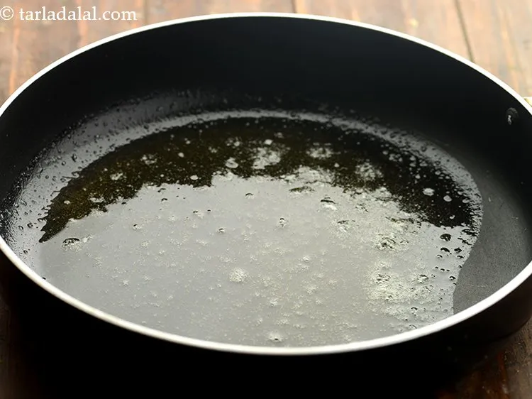 Step 11 – For tempering of <strong>cumin rice</strong>, heat a broad non-stick pan and add the oil and …