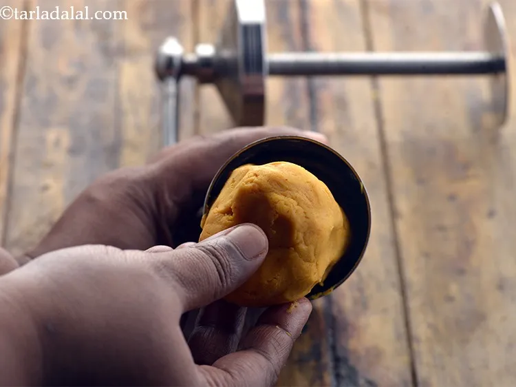 Step 11 – Put a portion of the dough into it. Press it lightly.