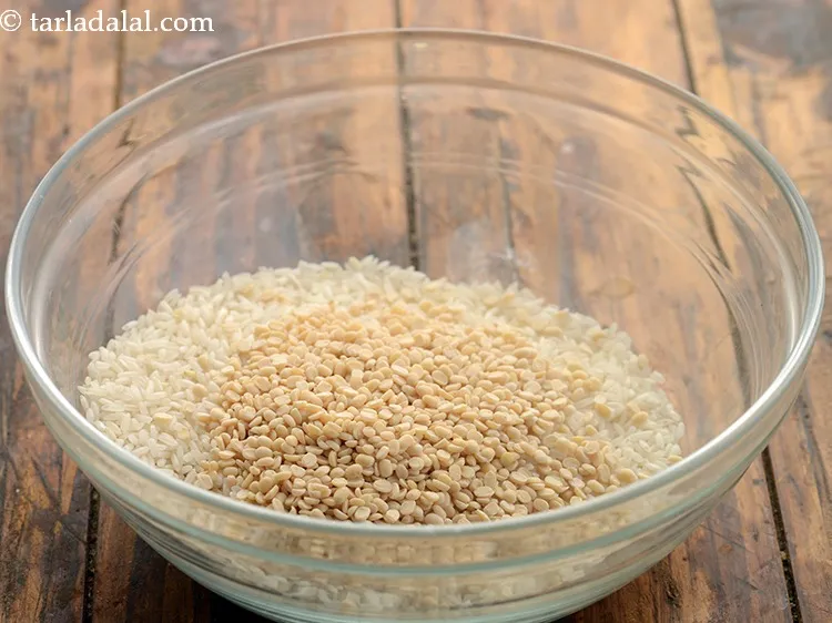 Step 2 – Add the urad dal. Wash it well under running water.