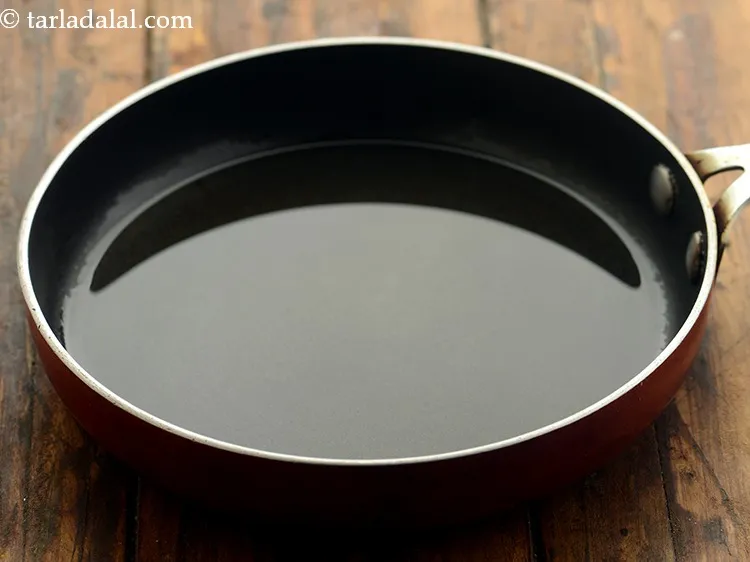 Step 13 – After the batter is fermented, heat the oil in a small non-stick pan.