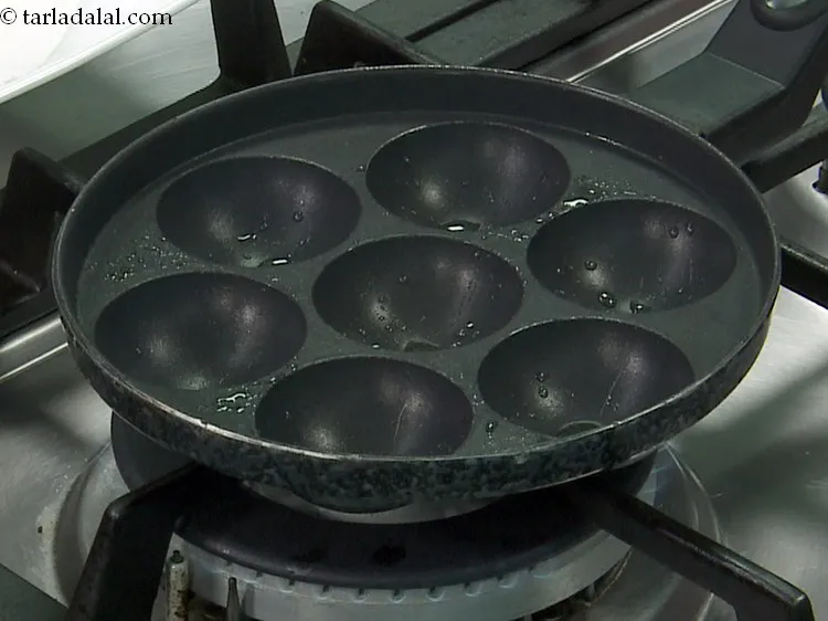 Step 25 – <div> Heat the appe mould on a medium flame and grease it using &frac14; tsp …
