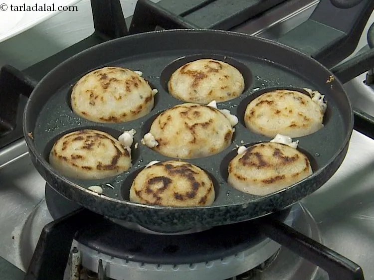 Step 28 – Then turn each appe upside down using a fork so as to cook them from …