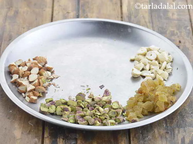 Step 9 – We have also chopped different nuts viz. almonds, cashewnuts and pistachios along with some raisins …