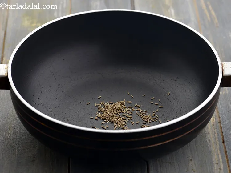 Step 2 – For making the <strong>rice khichu</strong>, in a deep non-stick pan, take cumin seeds. Also, you …