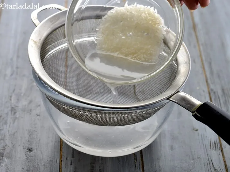 Step 9 – Drain using a strainer. Keep the washed rice aside.