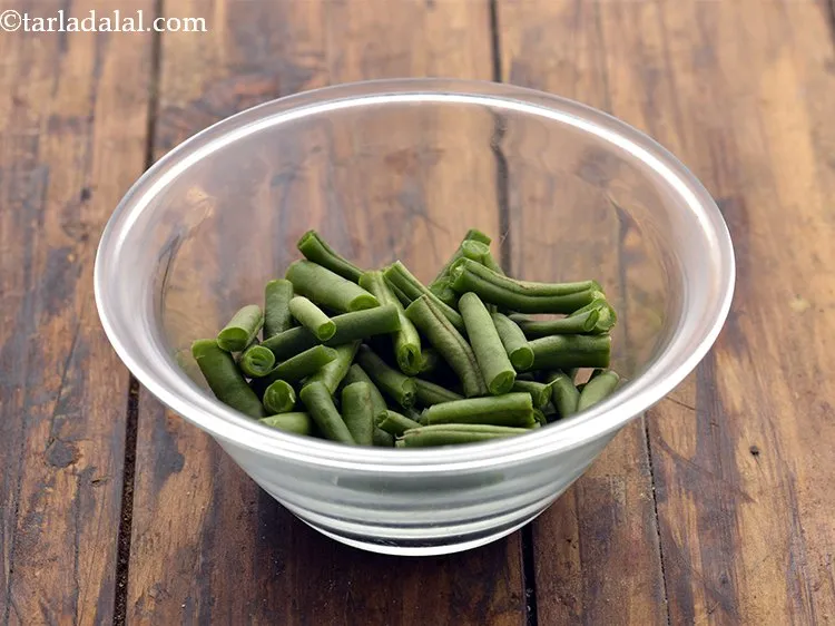 Step 7 – Take the French beans in a microwave safe bowl.