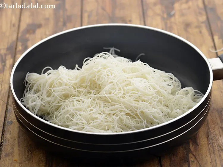 Step 12 – Once the oil is moderately hot, add the rice noodles.