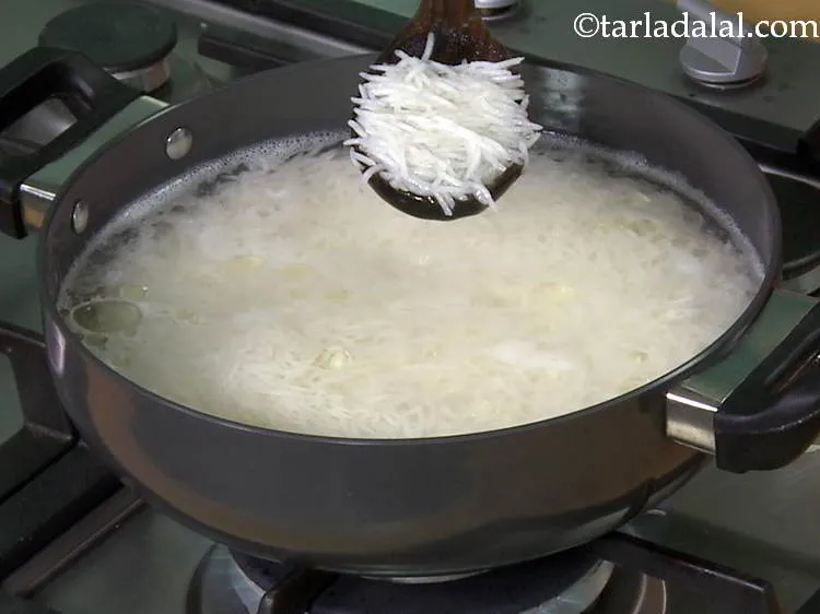 Step 9 – Boil 4 cups of water in a deep non-stick pan, add the soaked and drained …