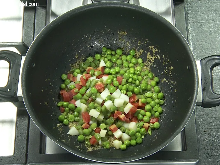 Step 16 – Add&nbsp;1/4 cup&nbsp;<a href="https://tarladalal.com/glossary-boiled-green-peas-1078i">boiled green peas</a>.