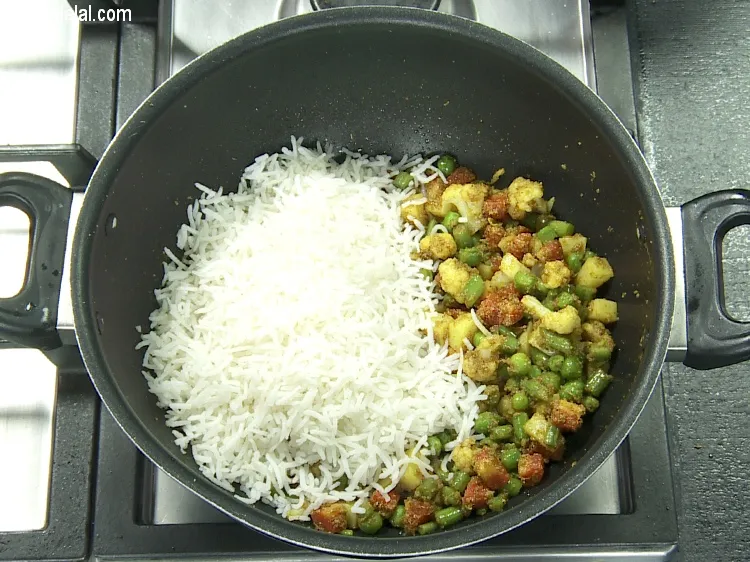 Step 23 – Add&nbsp;2 cups&nbsp;<a href="https://tarladalal.com/cooked-long-grained-rice-22657r">cooked long grained rice</a>.